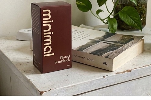 minimal Tinted Sunblock box on a bedside table